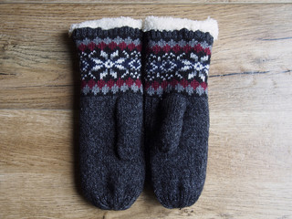 Mittens on wood background