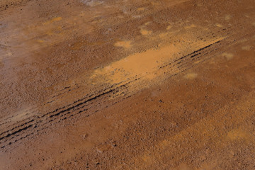 Vehicle track on soil ground the road is water for protect dust