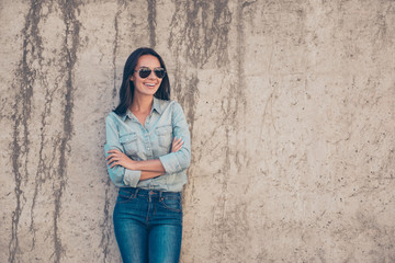 Happy smiling young woman in glasses with crossed hands