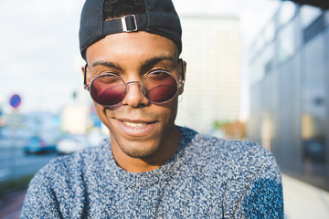 Young handsome american african swag man outdoor in the city looking in camera, rebel - rebellion,...