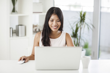 Asian Woman Surfing the Net at Home