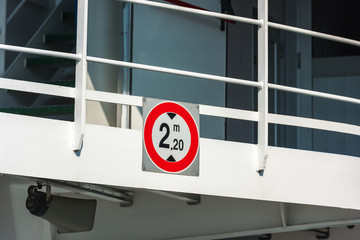 Sign of height restriction at the entrance to the ferryboat