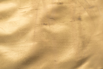Gold texture with bumps, scuffs and scratches Golden background
