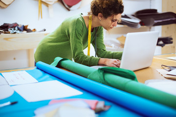 Clothes designer working in her atelier