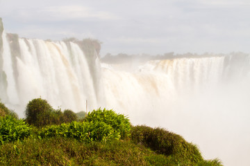 Iguazu (Iguacu) falls, largest series of waterfalls on the planet, located between Brazil, Argentina, and Paraguay with up to 275 separate waterfalls cascading along 2,700 meters (1.6 miles) cliffs.