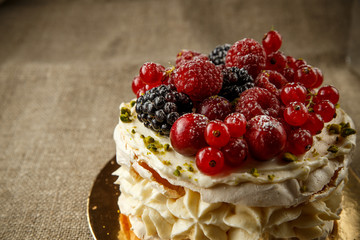 Pavlova, a home made cake from layers of meringue, whipped cream, and fresh berries