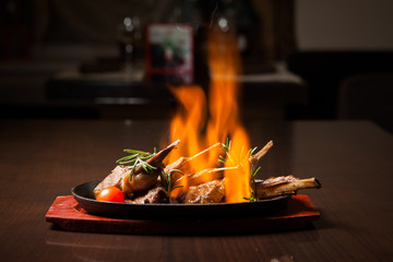 Juicy roasted Prime rib with herbs under fire