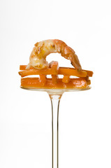 Schrimp and carrots on a reversed glass