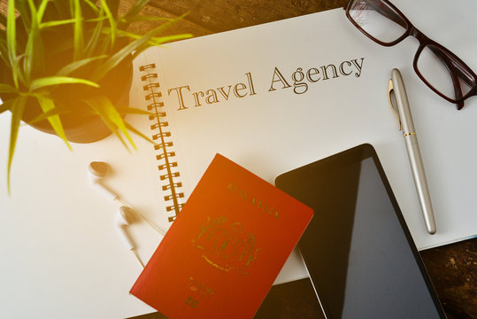 "Travel Concept " info text Travel Agency on note book with smart phone,passport,earphone,pen and glasses.Top View.
