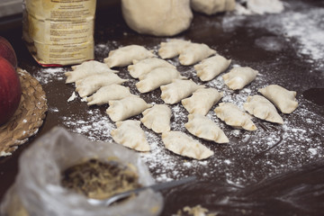 Homemade Dumplings prepared on the wooden brown table by traditional way