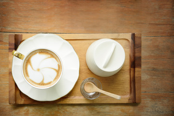 Coffee cup of hot latte art on table wood