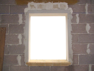 A window in an unfinished house (raw walls). The inside is bright white (ready to be mixed with...