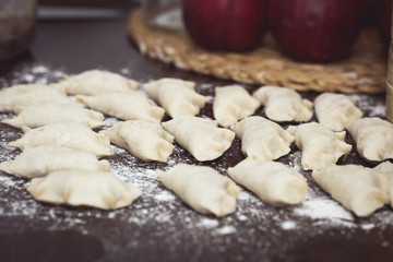 Homemade Dumplings prepared on the wooden brown table by traditional way