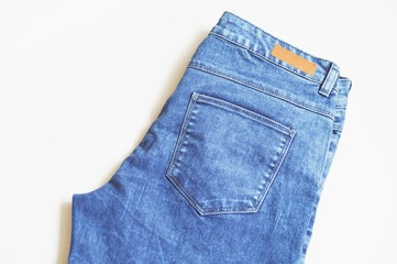 Blue jeans closeup/ Women's jeans trousers. Blue stylish denim clothes. Trendy wear. Flat lay fashion background