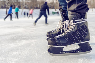 Close-up of ice skating shoes on a rink - obrazy, fototapety, plakaty