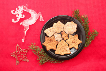 Christmas cookies and decorations on red background