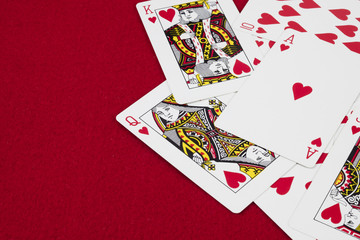 Detail of heart deck poker playing cars in red background