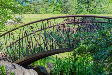 Artistic bridge in green lush garden setting.  Sarah P. Duke gardens in Durham, NC.