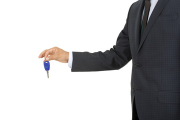 Man in a suit holding a car key