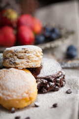 Mix flavour of scone biscuit decorate with chocolate ship and fresh strawberry and blueberry