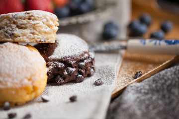 Mix flavour of scone biscuit decorate with chocolate ship and fresh strawberry and blueberry