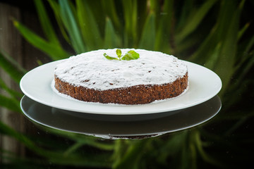 Delicious chocolate cake on plate on table on light background