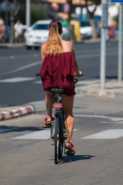 Woman riding on bicycle around the city.