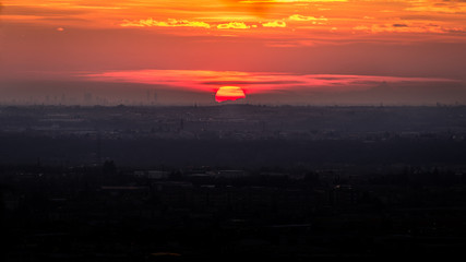 Obraz premium sunset on Po Valley view from Bergamo hill's - is visible on the horizon the skyline of Milan city