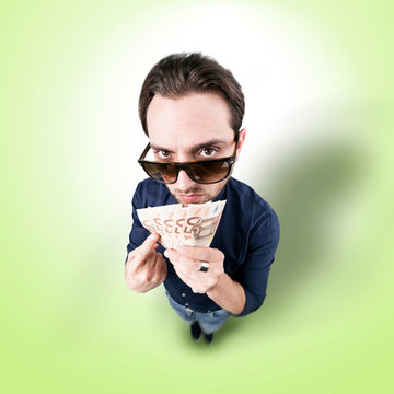 Funny man with money from above looking in camera