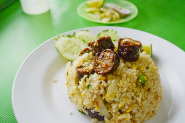 Fried rice with Thai spicy sausages Northern style.on green table