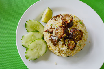 Fried rice with Thai spicy sausages Northern style.on green table