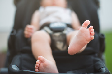 newborn baby feet sitting in carriage or buggy