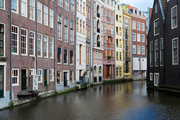 Fototapeta na wymiar Facades of old histoic Houses over canal water, Amsterdam, Netherlands