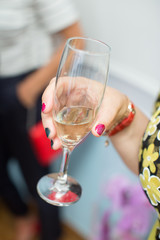 Woman holding glass champagne or sparkling wine