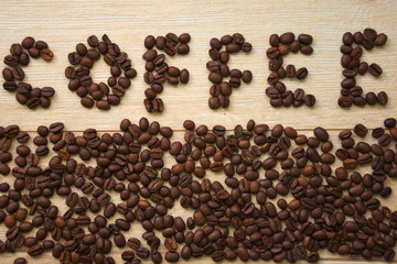 Inscription of coffee beans arranged in word coffee