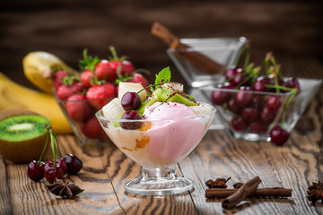 Banana split sundae ice cream in a bowl with strawberry and raspberry vanilla icecream scoops