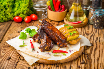Grilled barbecue pork ribs on wooden board