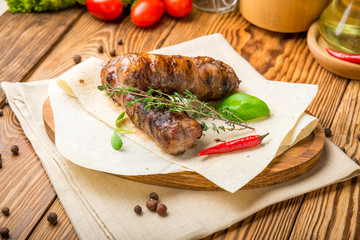 Grilled sausages with sauce on a wooden table