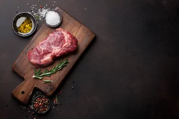 Photo sur Plexiglas Steakhouse Raw ribeye beef steak cooking with ingredients