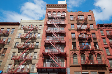 New York buildings with fire escape stairs, sunny day