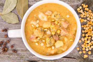 Split pea soup, decorated with some bay leaves, marjoram and peas