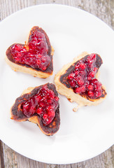 Heart shaped pancakes with cowberry jam