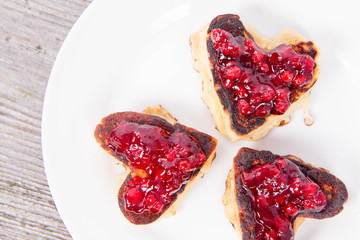 Heart shaped pancakes with cowberry jam