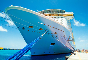 Cruise vacation concept. Cruise ship docked in tropical port. Passenger go to the ship in the...