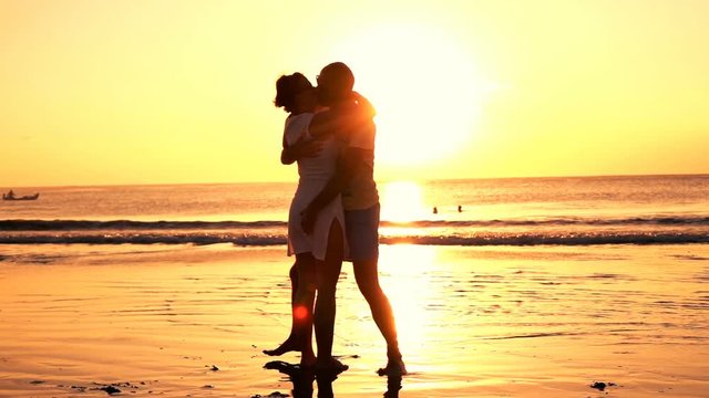 Young couple in love, kissing on beach during sunset, super slow motion 240fps
