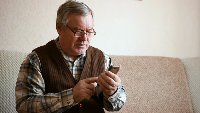 Old elder senior man on mobile smart phone