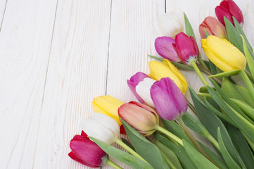 bouquet of tulips on rustic wooden board, easter decoration
