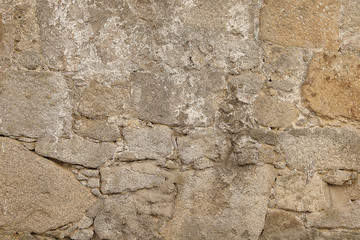 Old beige stone wall background texture