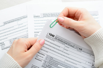 Female hands and tax form