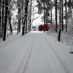 car tire tracks on winter road with road signs